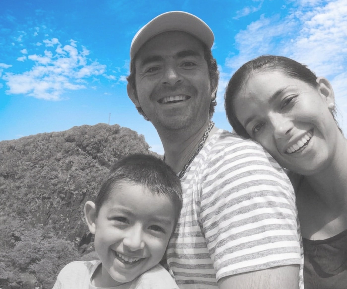 Konsta as a child with his parents, smiling outdoors
