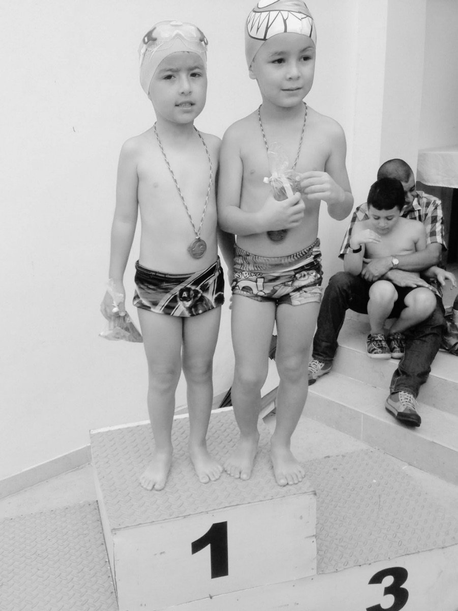 Two children with medals on a competition podium