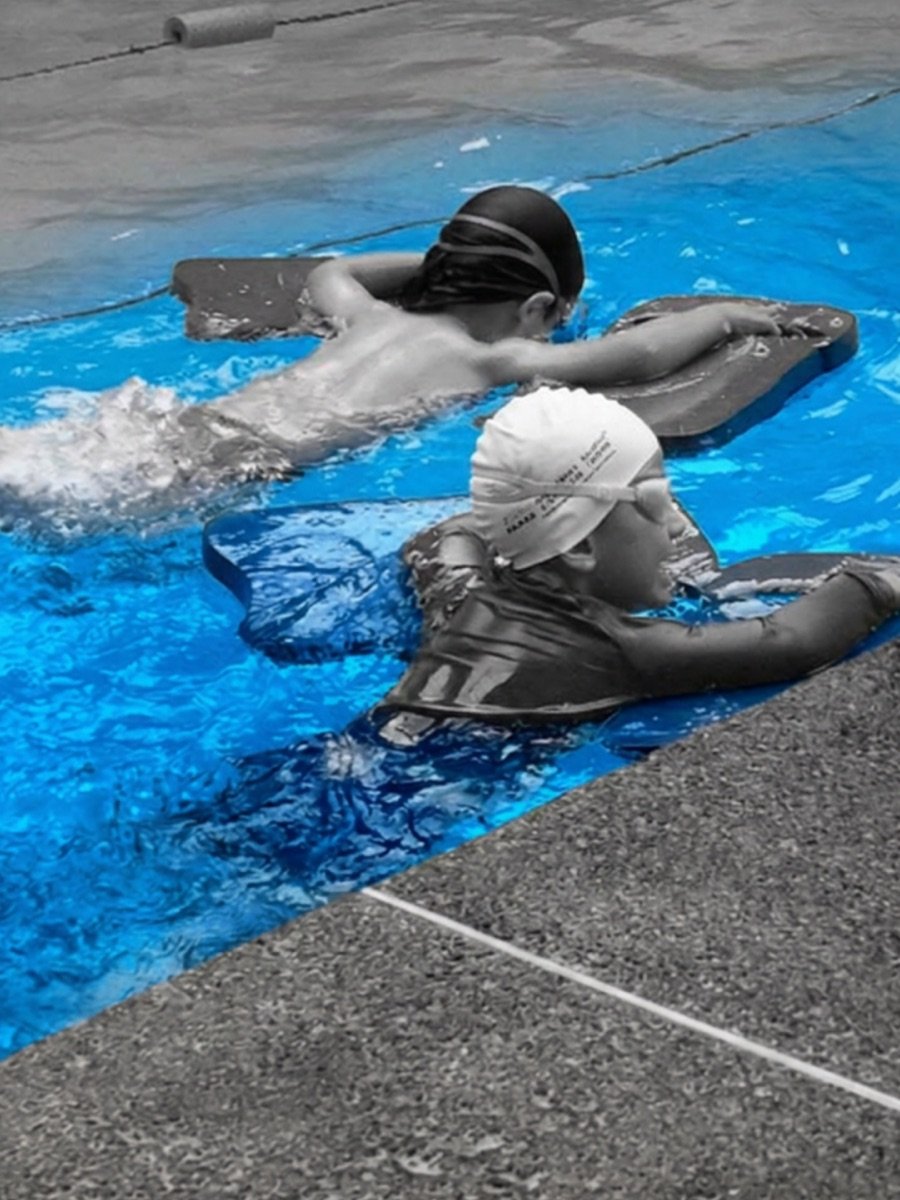 Two swimmers training with monofin and kickboard